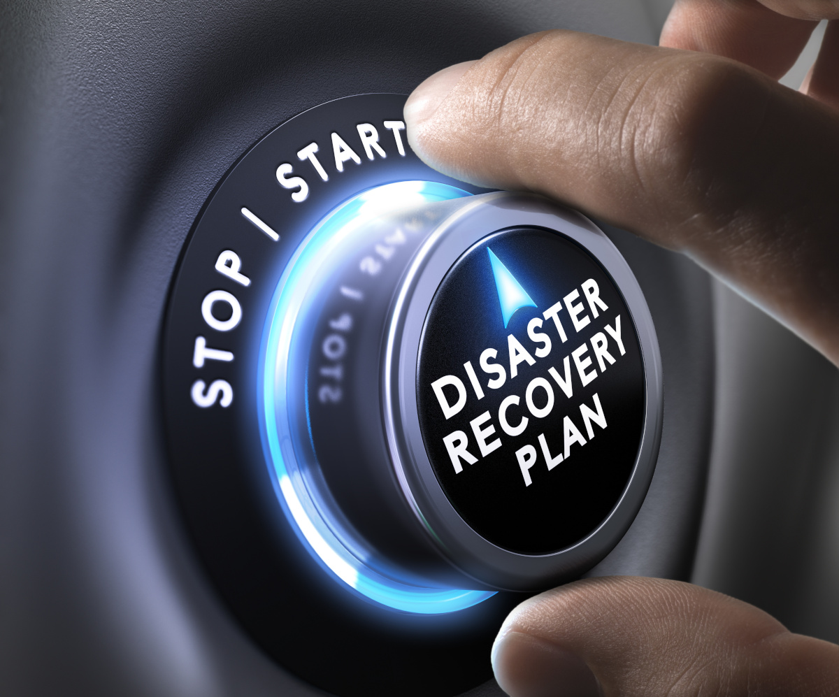 A hand turning a dial that says Disaster Recovery Plan 'from stop to start'