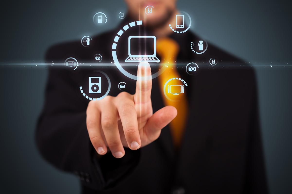 Man pointing at digital devices icons